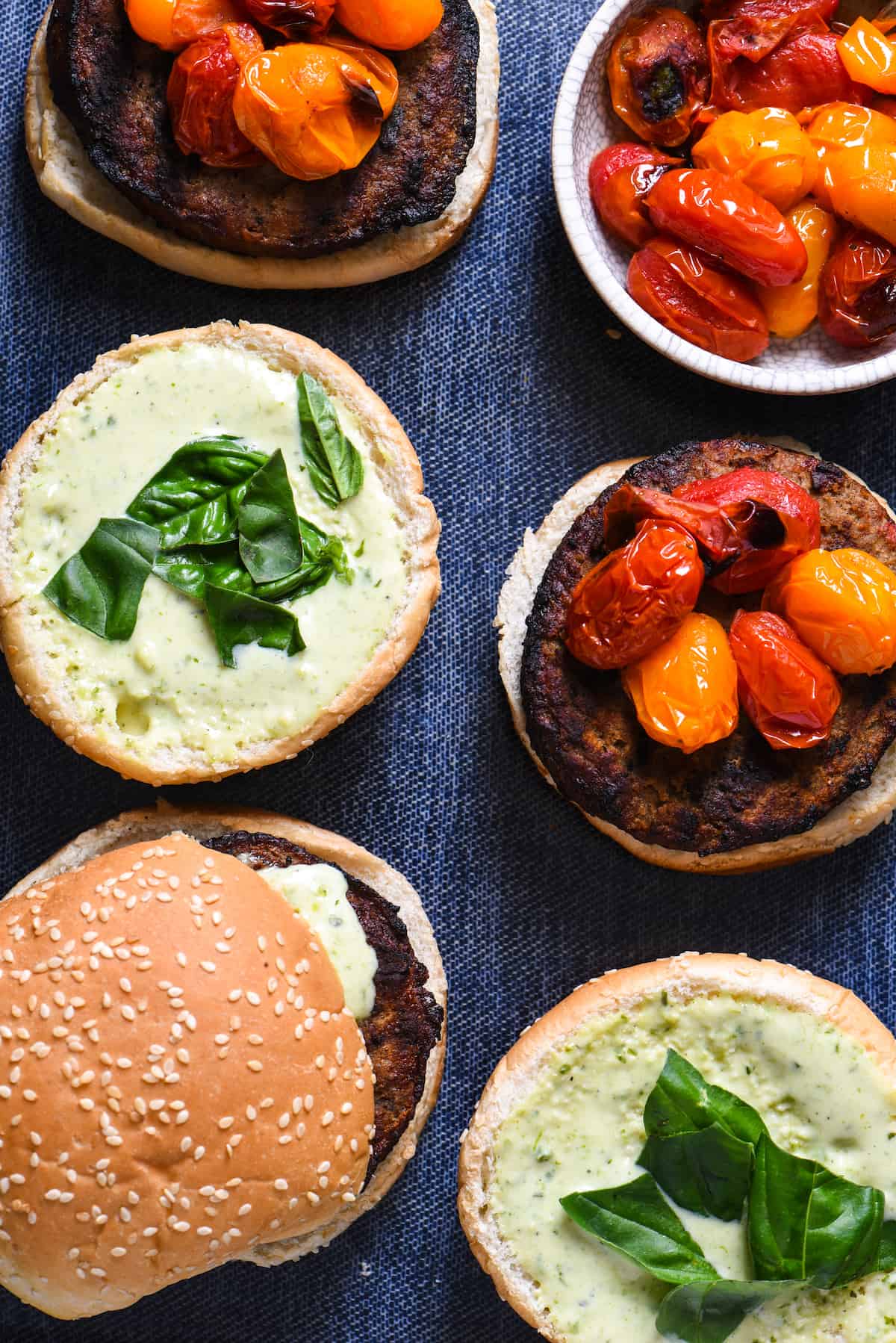 Grill-Roasted Tomato Turkey Burgers with Pesto Ranch - Spruce up burger night with homemade pesto ranch dressing, and tomatoes that are "roasted" on the grill in a foil packet. | foxeslovelemons.com