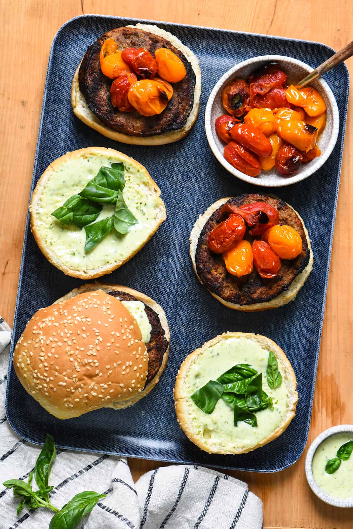 Grill-Roasted Tomato Turkey Burgers with Pesto Ranch - Spruce up burger night with homemade pesto ranch dressing, and tomatoes that are "roasted" on the grill in a foil packet. | foxeslovelemons.com