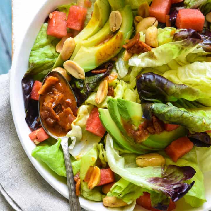 Watermelon and Avocado Salad with Warm Bacon Dressing - An irresistible sweet and savory summer salad! Butter lettuce, watermelon, avocado and peanuts are topped with an easy warm bacon dressing. | foxeslovelemons.com