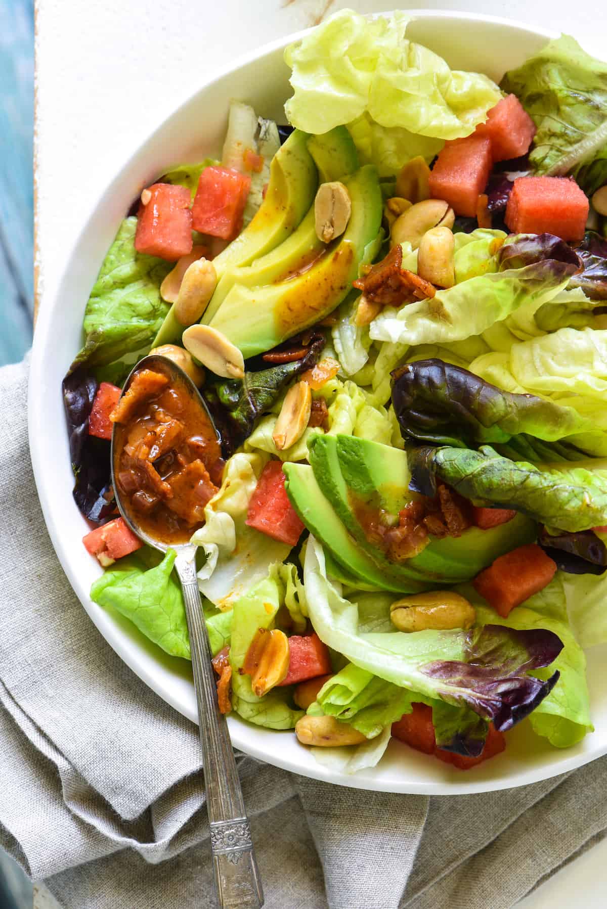 Watermelon and Avocado Salad with Warm Bacon Dressing - An irresistible sweet and savory summer salad! Butter lettuce, watermelon, avocado and peanuts are topped with an easy warm bacon dressing. | foxeslovelemons.com