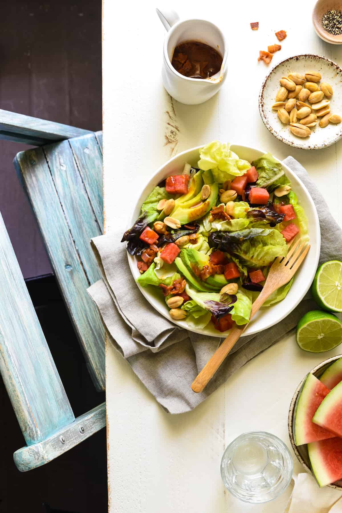 Watermelon and Avocado Salad with Warm Bacon Dressing - An irresistible sweet and savory summer salad! Butter lettuce, watermelon, avocado and peanuts are topped with an easy warm bacon dressing. | foxeslovelemons.com