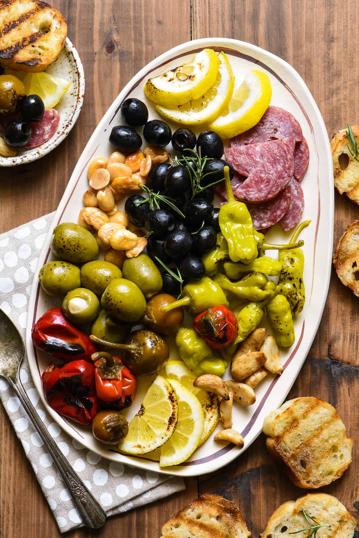Fill a foil packet with olives, peppers, nuts and salami and throw it on the grill! This Grill-Roasted Antipasto will be the easiest summer appetizer you'll ever make! | foxeslovelemons.com