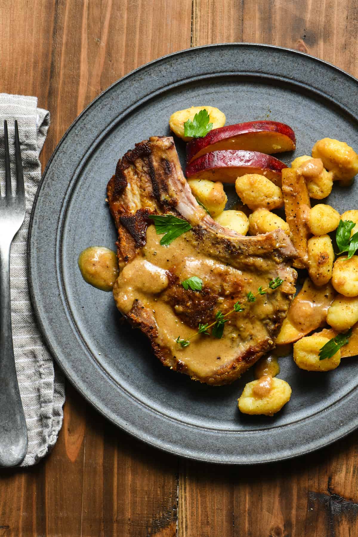 Bring dinner to the table in a single pan with this Skillet Pork Chops with Apple Gnocchi Sauté recipe. Glaze everything with a hard cider sauce (or sub traditional apple cider) for a restaurant-quality meal that YOU can make at home on a weeknight. | foxeslovelemons.com