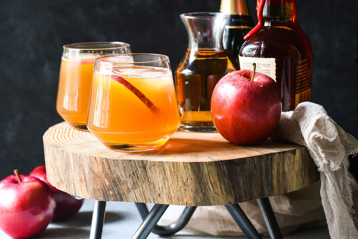 Serve a crowd with this Bourbon Apple Cider Punch! Don't be stuck in the kitchen making a craft cocktail for each party guest. With just 4 simple ingredients, this spiked punch can be stirred together in just a minute. Use bourbon, rum, or any other spirit you like.  | foxeslovelemons.com