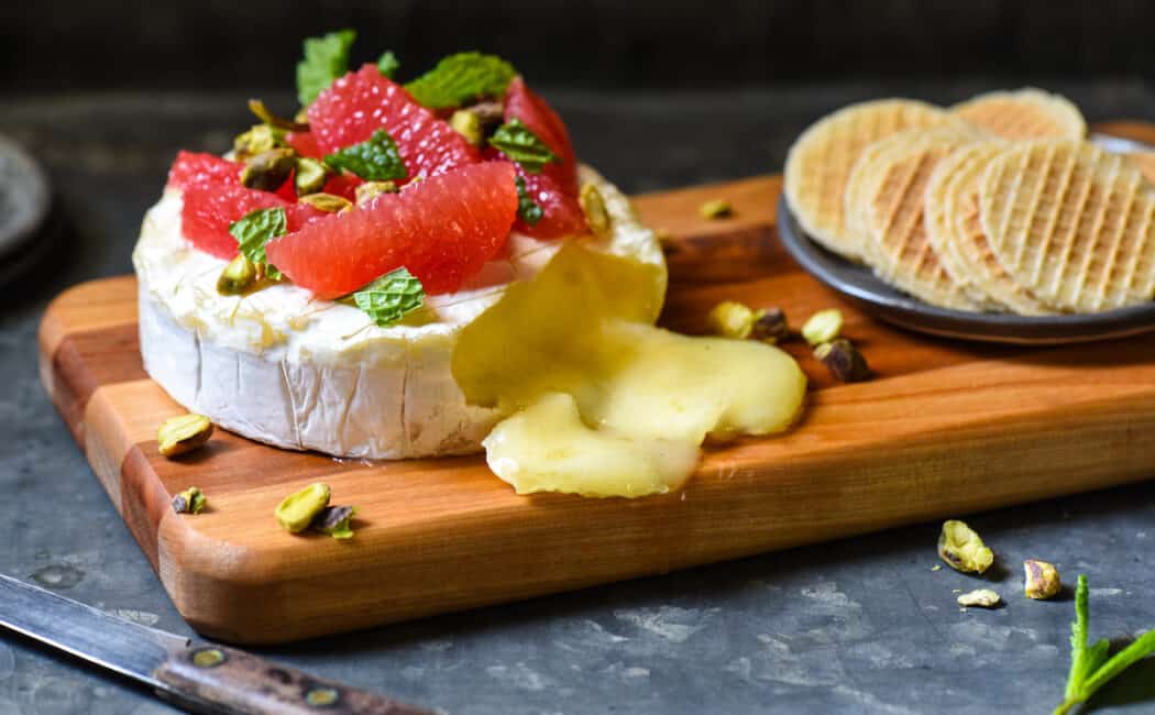 With just 4 ingredients and a 10 minute prep time, this Easy Baked Brie with Grapefruit & Pistachios is ideal for a party, or just a delicious snack at home. | foxeslovelemons.com