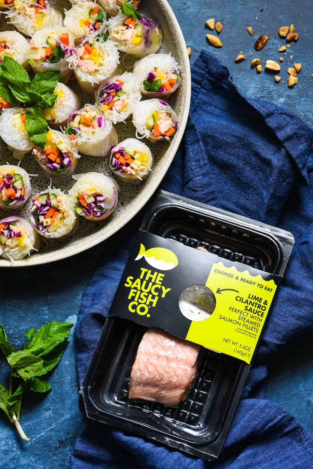 Serve the rainbow with these Salmon Fresh Rolls with Spicy Peanut Sauce. Perfect as a bright party appetizer or healthful dinner, be a "home chef" and make this takeout-inspired recipe at home! | foxeslovelemons.com