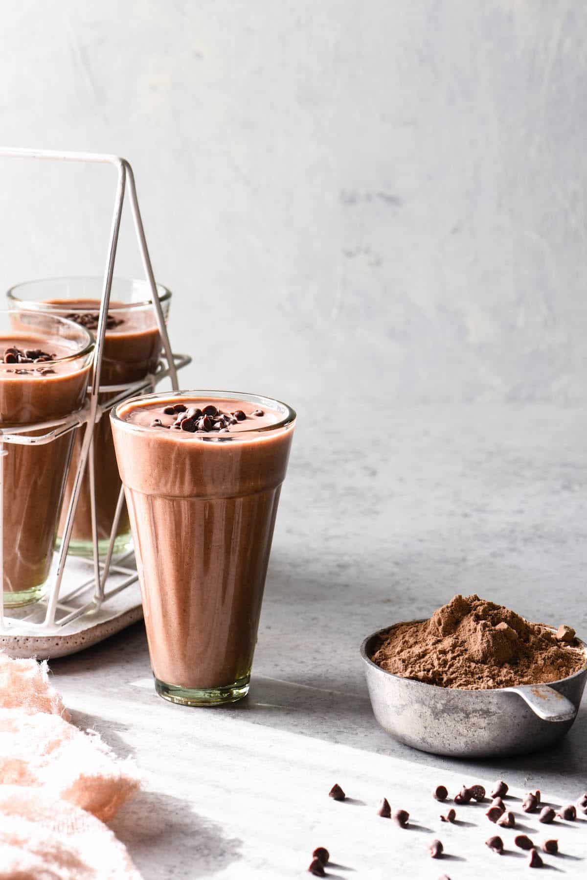 Blend up this High Protein Cocoa Smoothie for an energizing breakfast, or recovery after a workout. Fruity and full of chocolate flavor, it feels decadent while still being good for you!  | foxeslovelemons.com