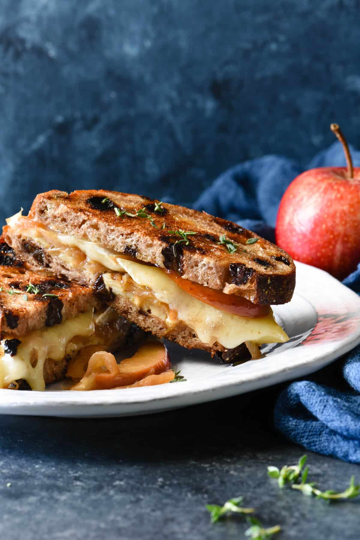 This Apple Grilled Cheese is an irresistible combination of sautéed apples, sweet caramelized onions, brie and white cheddar cheeses, Dijon mustard and walnuts. It's the best toasted sandwich you've ever made at home! | foxeslovelemons.com