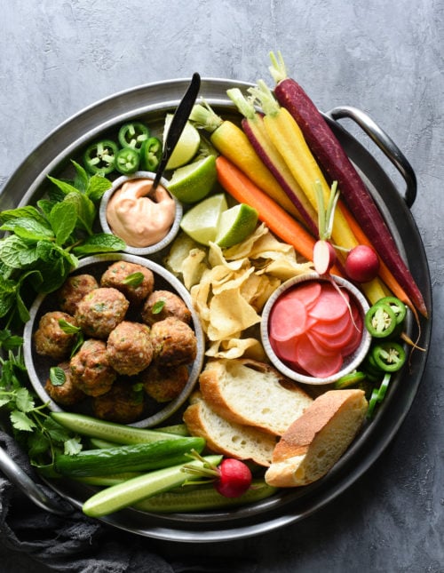 This Banh Mi Meatball Snack Dinner is a healthful platter of fresh ingredients that the whole family will love. Turkey meatballs, fresh and pickled veggies, bread, potato chips and dipping sauce - it's a fun meal that comes together easily. | foxeslovelemons.com