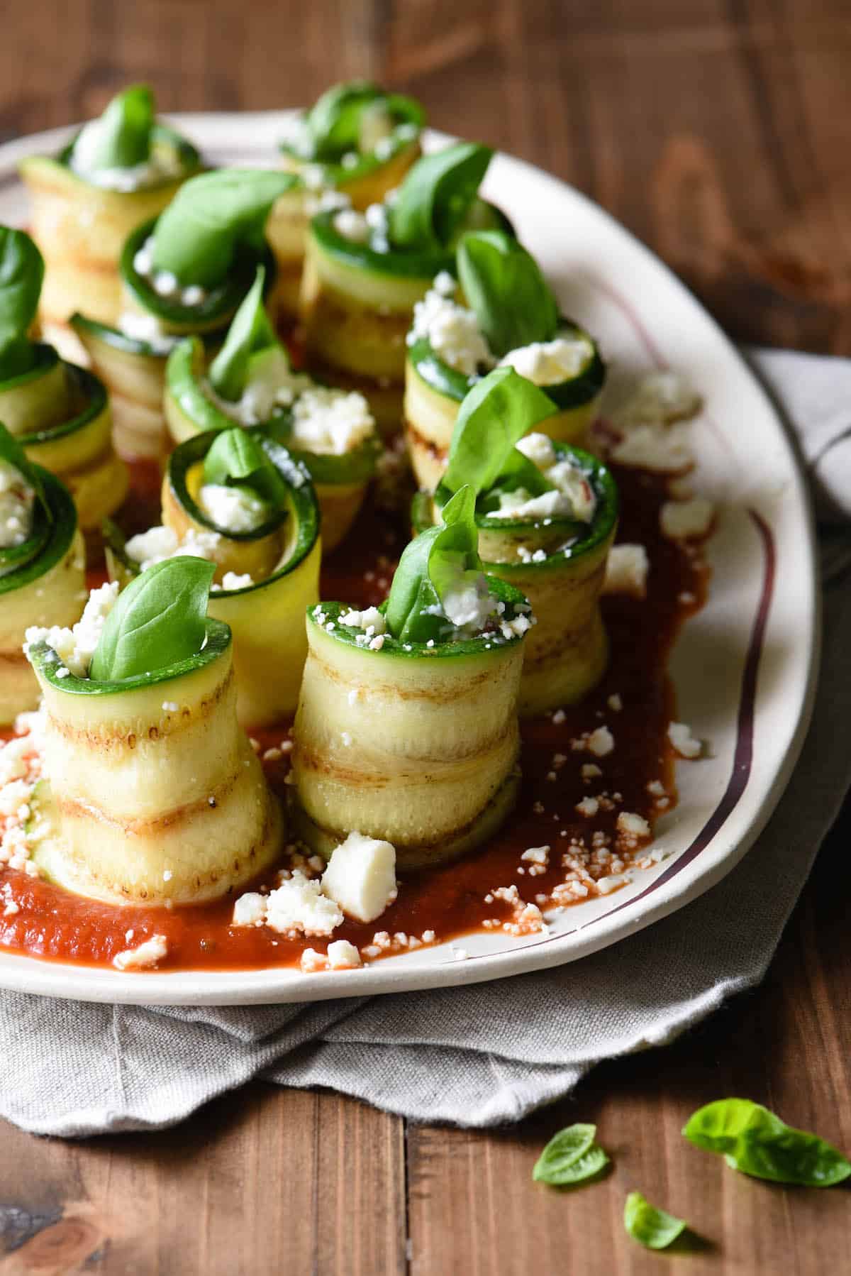 Use your grill to prepare these easy but elegant Grilled Zucchini Roll Ups with Feta. Serve as a party appetizer, a vegetable side dish, or even a light summer meal. | foxeslovelemons.com