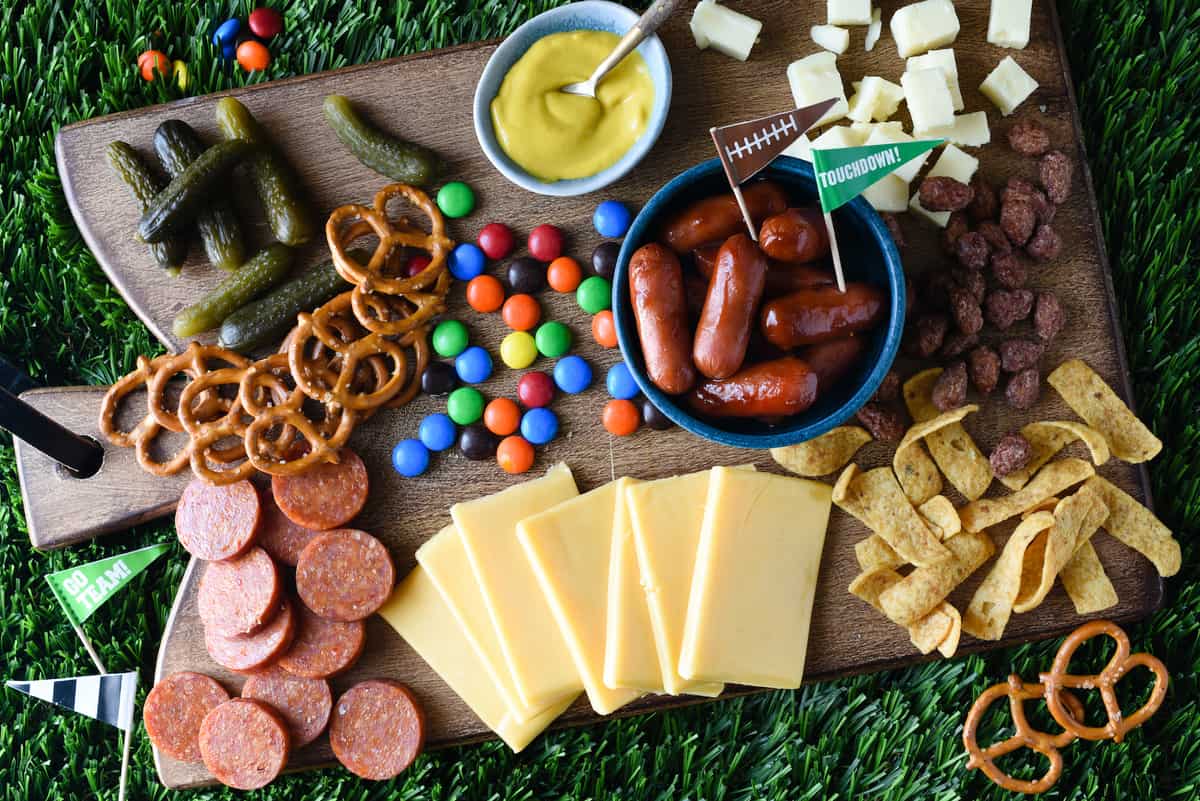 Keep your football parties delicious this fall with a platter piled high with sweet and salty snacks. Fans of all ages will enjoy this Tailgate Cheese Board! | foxeslovelemons.com