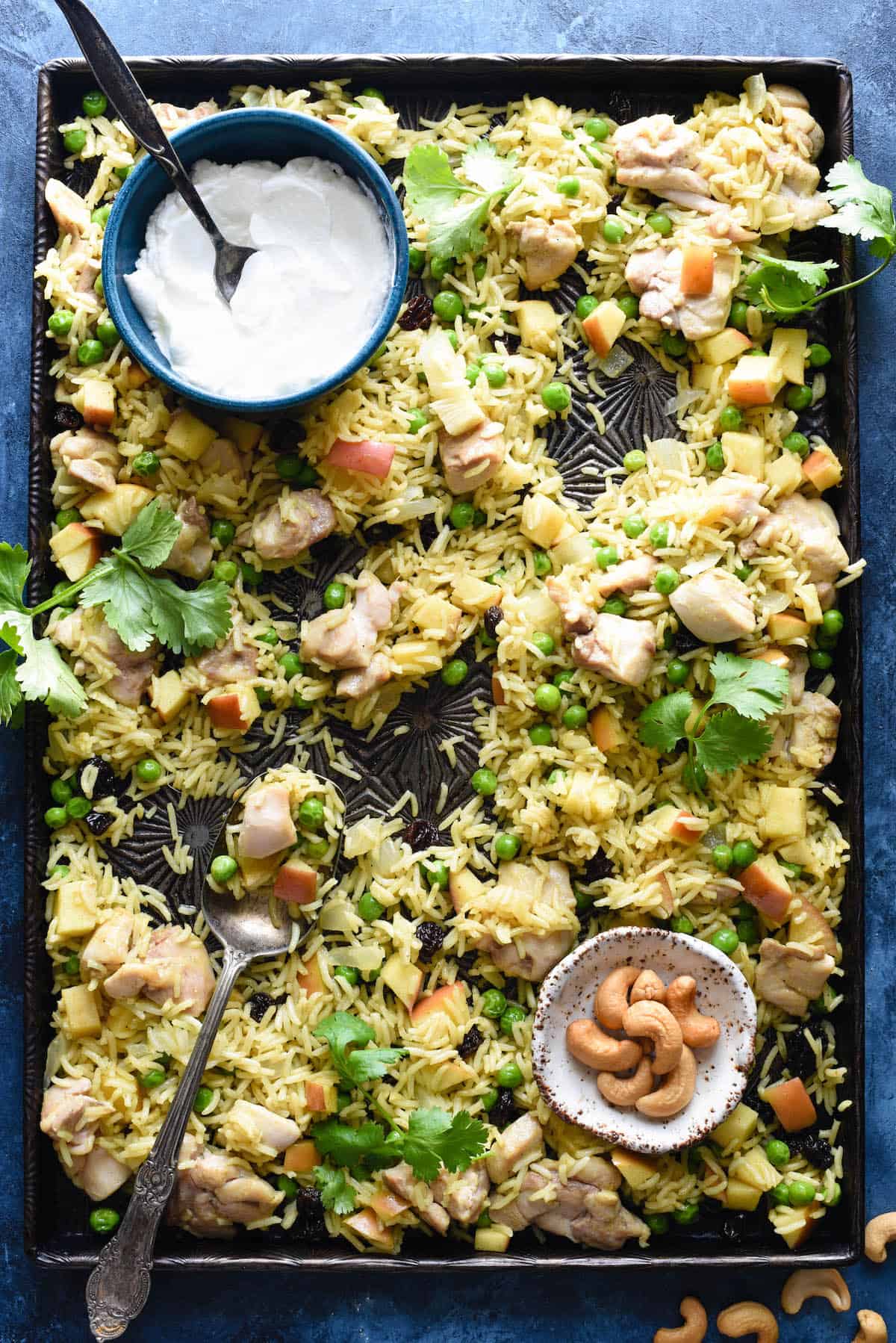 This easy Sheet Pan Chicken & Apple Curry is a complete meal on a pan, and will fill your family up with chicken, rice, fruits and vegetables. Everything goes onto a single baking pan! | foxeslovelemons.com