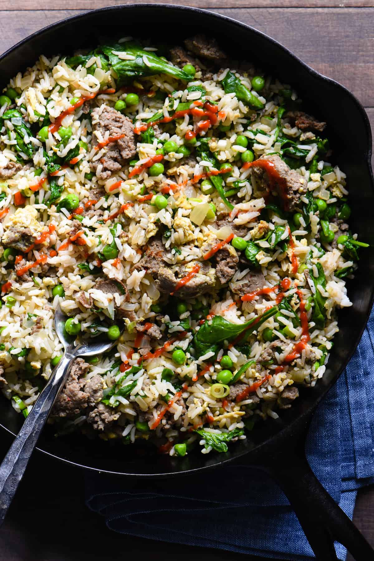 Break out a big cast iron skillet and feed a crowd with this Breakfast Fried Rice. Full of lean turkey sausage, eggs and lots of veggies, this will keep the crew fueled all morning. | foxeslovelemons.com