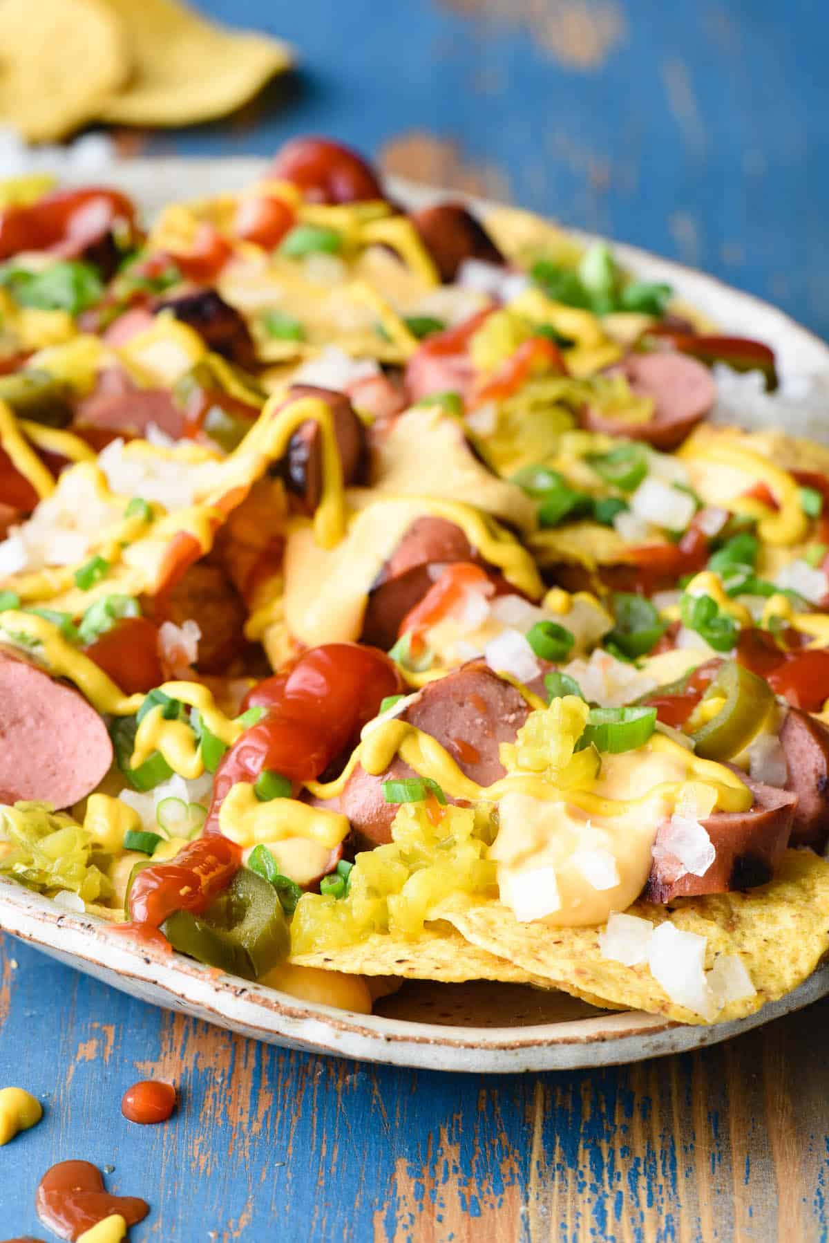 Celebrate baseball season with Hot Dog Nachos, a mashup of two ballpark foods! Includes recipe for homemade beer queso sauce. | foxeslovelemons.com