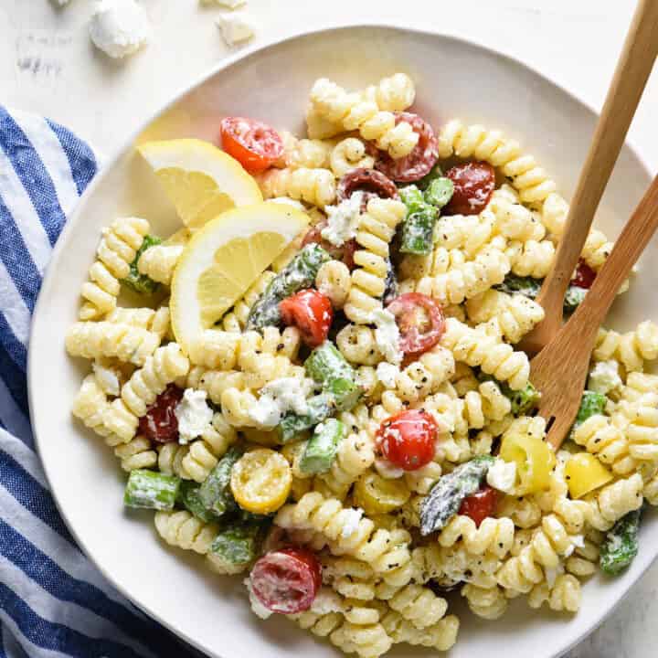 This creamy goat cheese pasta salad is simple to put together and will become a family favorite! Customize with any vegetables you like. | foxeslovelemons.com