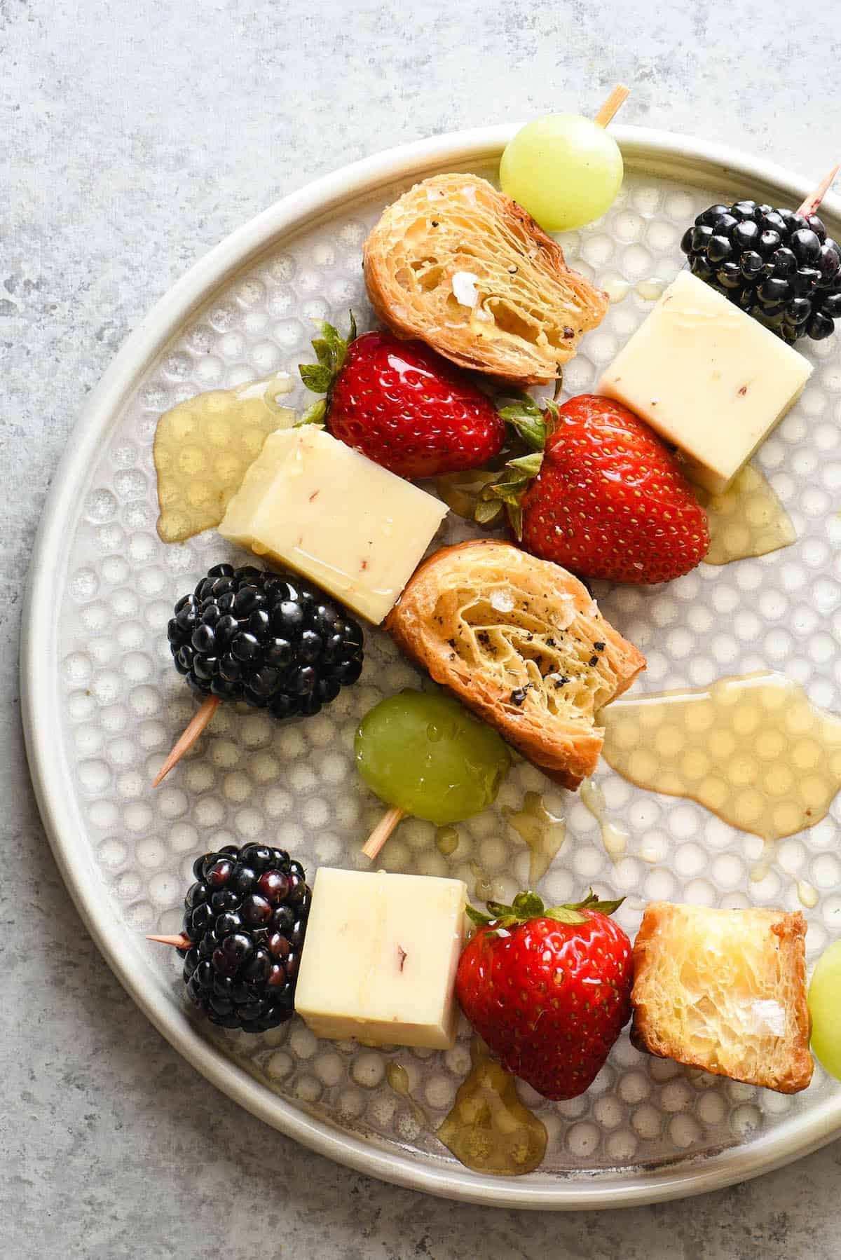 These fresh Fruit and Cheese Kabobs with Croissant Croutons are a nutritious snack that both kids and adults will love. This colorful combination of sweet fruit, savory cheese and flaky croutons comes together in a snap. | foxeslovelemons.com