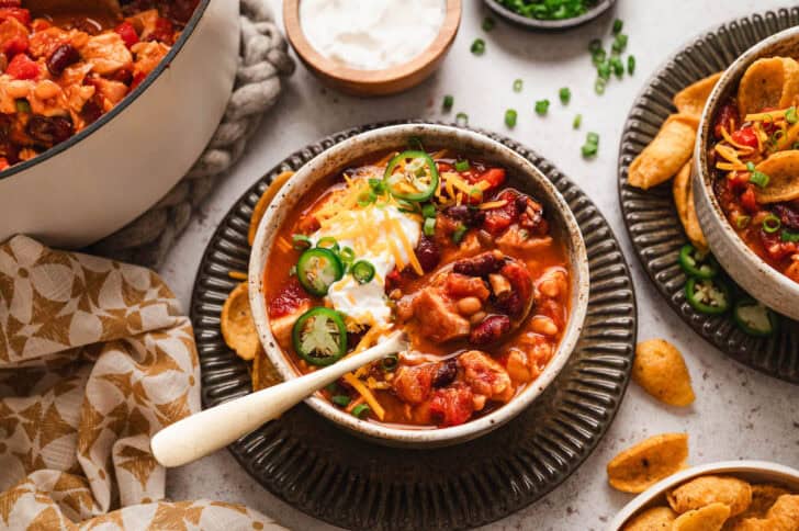 A bowl of the best turkey chili with a spoon scooping some out.