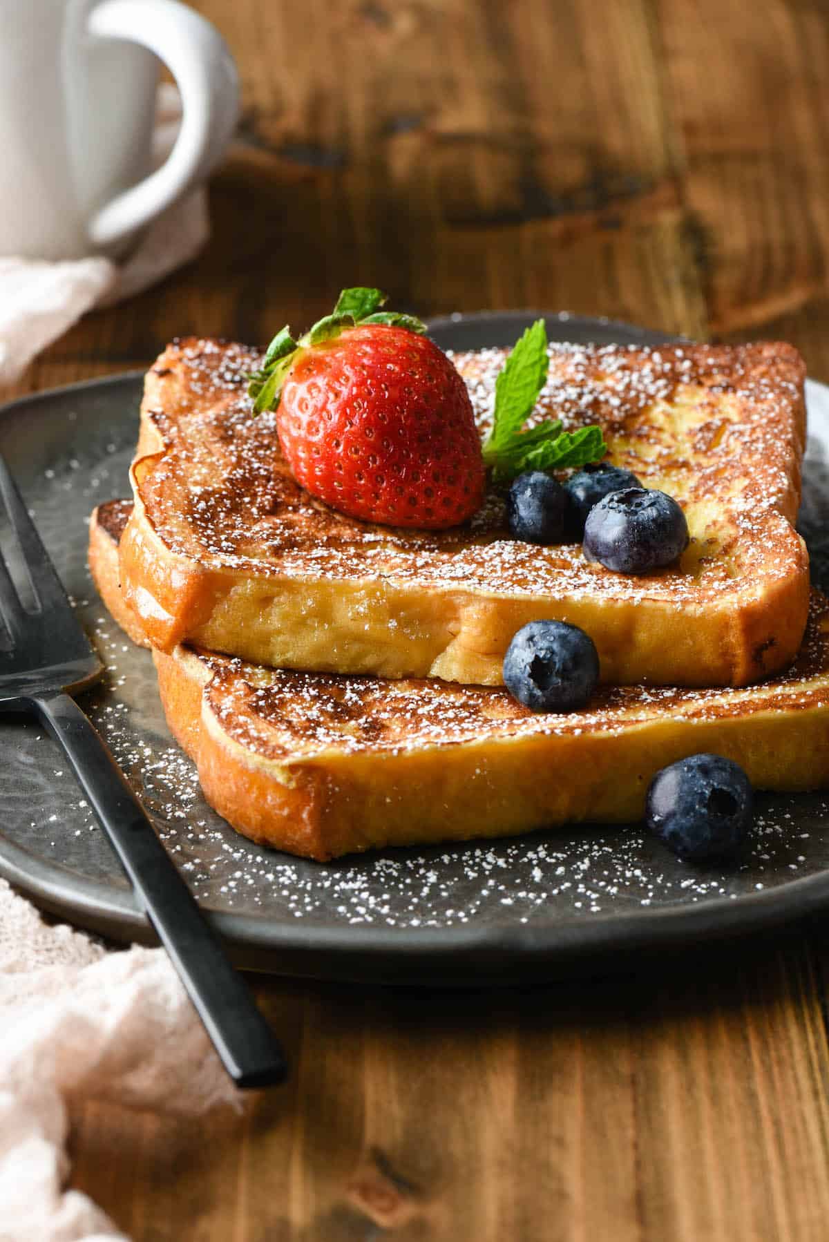 This Brioche French Toast is made with a secret ingredient! This easy-to-follow recipe makes a simple and sweet breakfast treat the whole family will love. | foxeslovelemons.com
