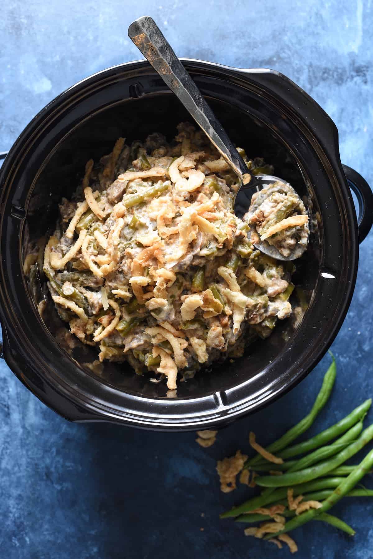 This Crockpot Green Bean Casserole is made with fresh beans and doesn't use canned soup. It's a yummy and easy upgrade to a classic dish, and doesn't take up oven space for a holiday meal! | foxeslovelemons.com