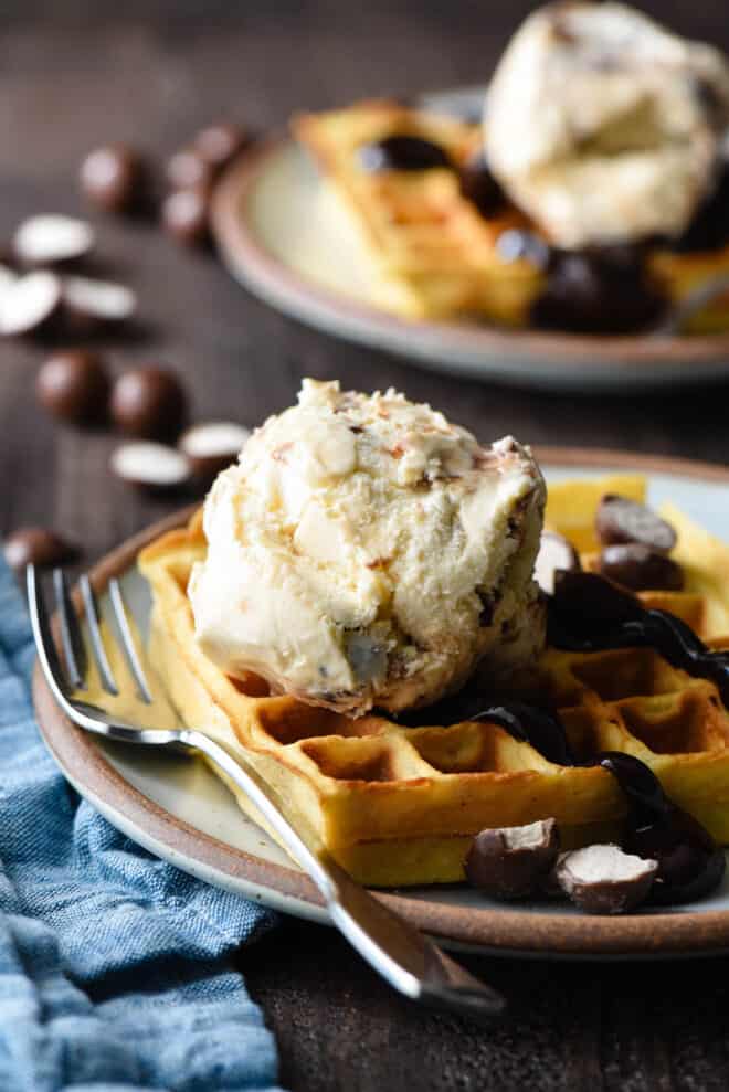 Golden brown waffle topped with hot fudge and a scoop of ice cream.