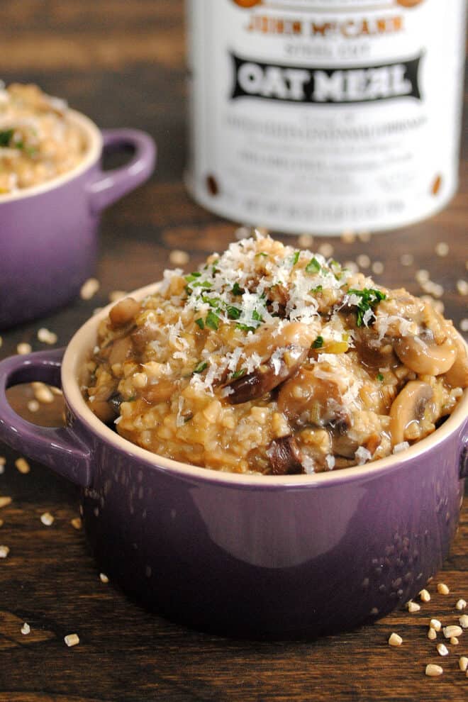 Small purple pot filled with mushroom risotto and topped with parmesan cheese.