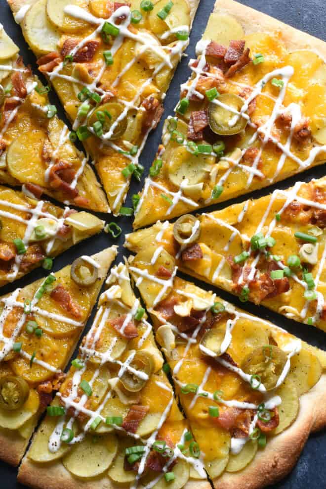 Closeup photo on savory pie topped with sliced spuds, bacon and ranch dressing.