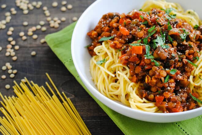 White bowl filled with noodles and vegan pasta sauce.