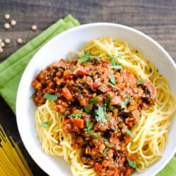 Large white bowl filled with spaghetti and vegan ragu.