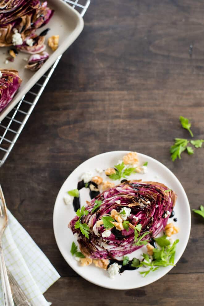 Roasted radicchio wedge topped with cheese, nuts, herbs and glaze.
