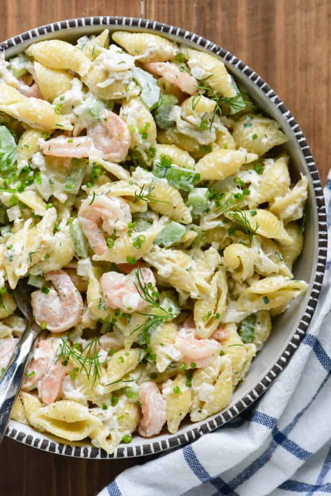 Serving bowl filled with creamy crab and shrimp pasta salad.