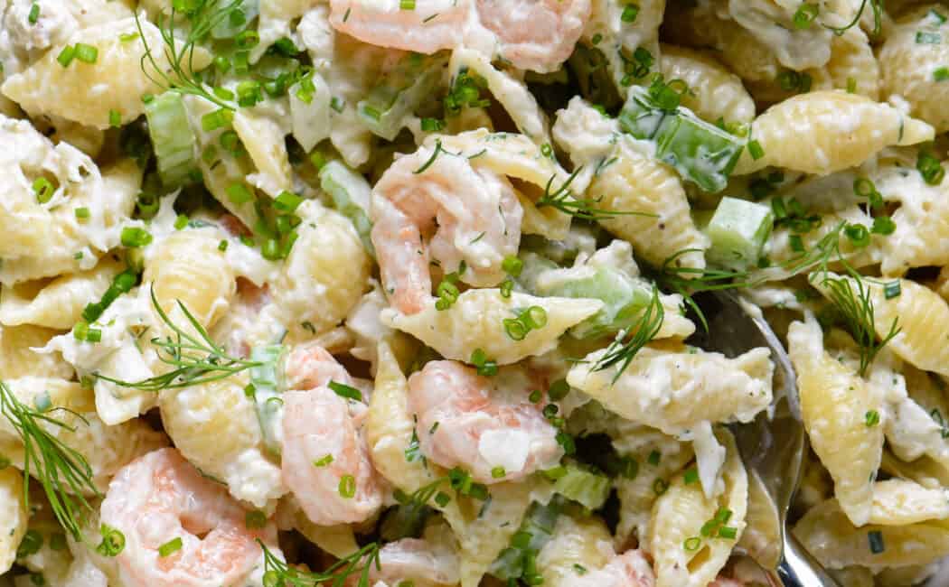 Serving bowl filled with shrimp and crab pasta salad.