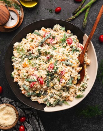 A bowl of Acini de Pepe pasta salad on a dark surface.