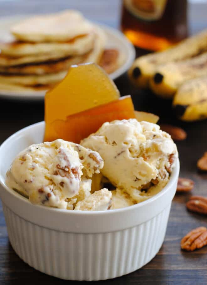 Large white ramekin filled with chunky homemade ice cream and maple brittle.