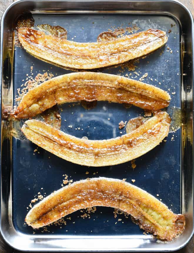 Small metal pan with 4 baked banana halves.