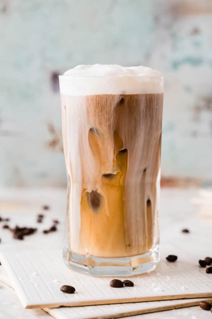 A large tall glass of salted caramel cream cold brew coffee.
