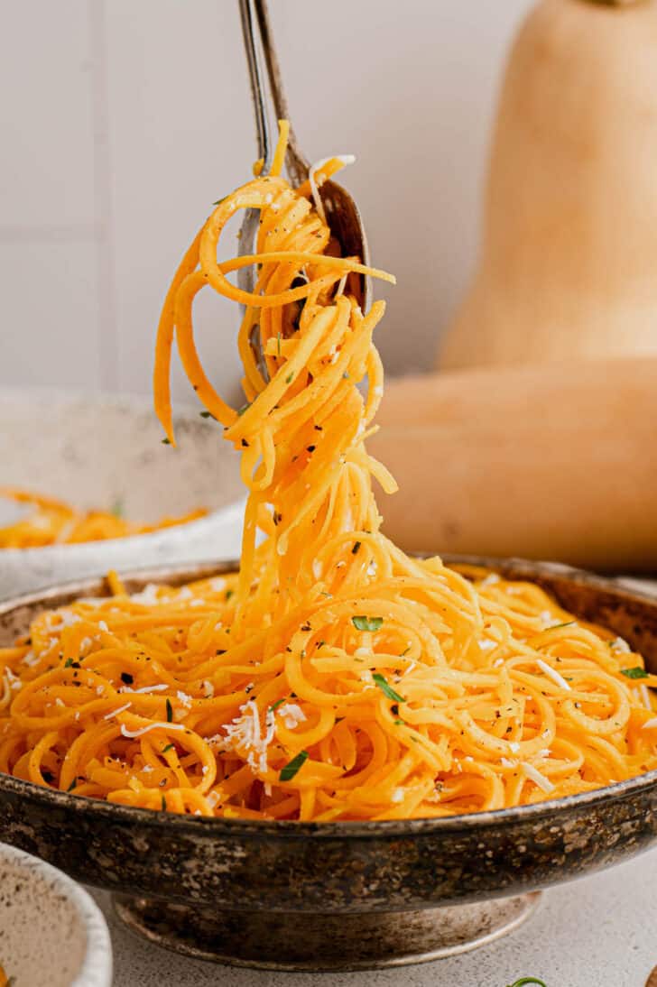 A fork twirling butternut squash spaghetti.