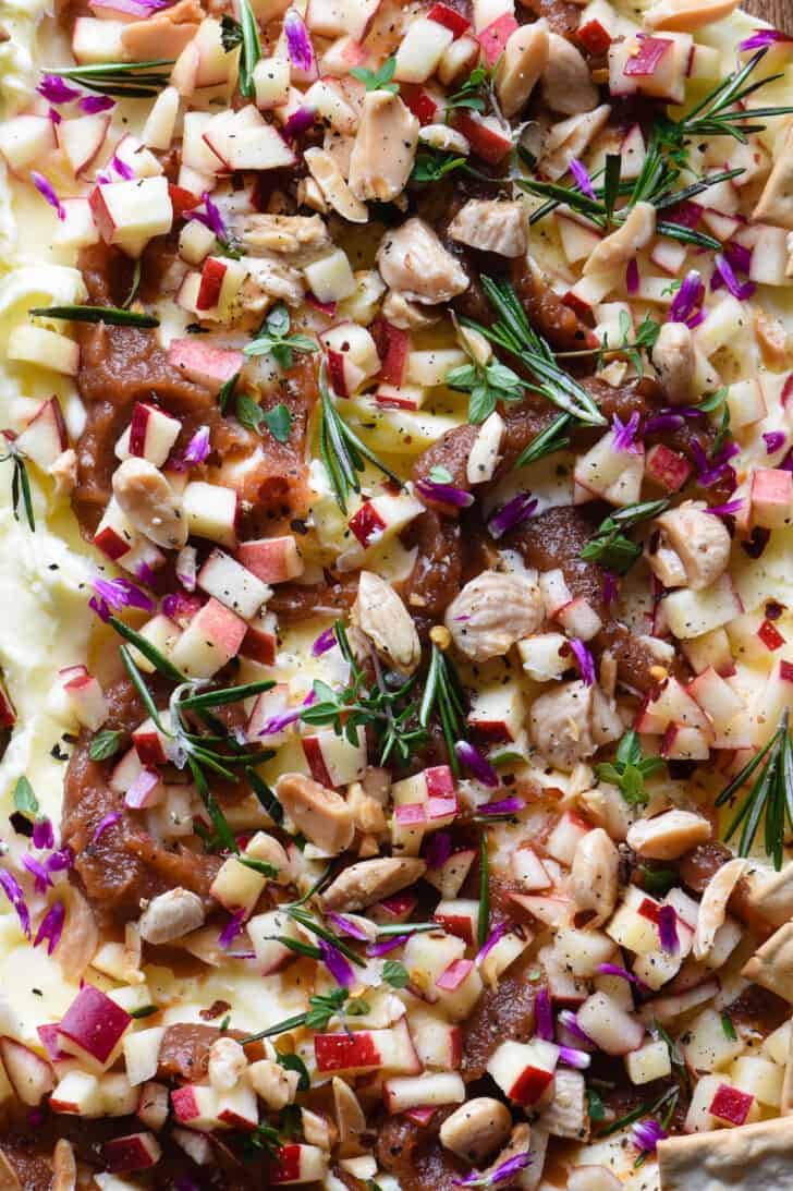 Softened butter topped with apple butter, fresh chopped apples, nuts, herbs and edible flowers.