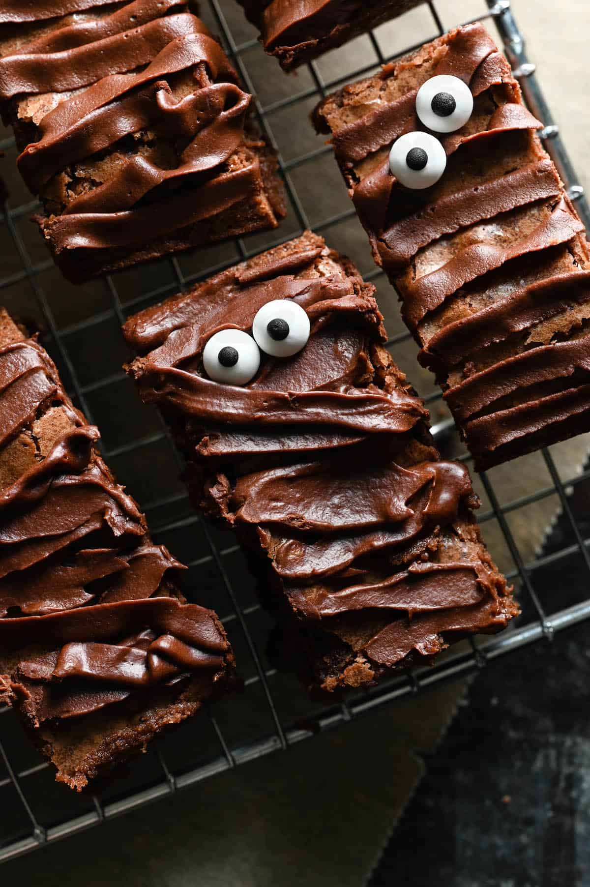Halloween brownie recipe with ganache frosting and candy eyeballs that look like mummies.
