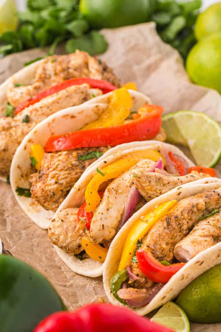 Sheet pan chicken fajitas served in flour tortillas.