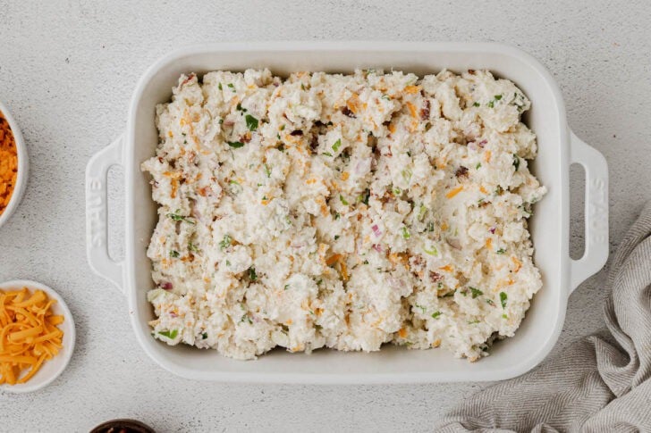 A white rectangle baking dish filled with a light colored casserole mixture.