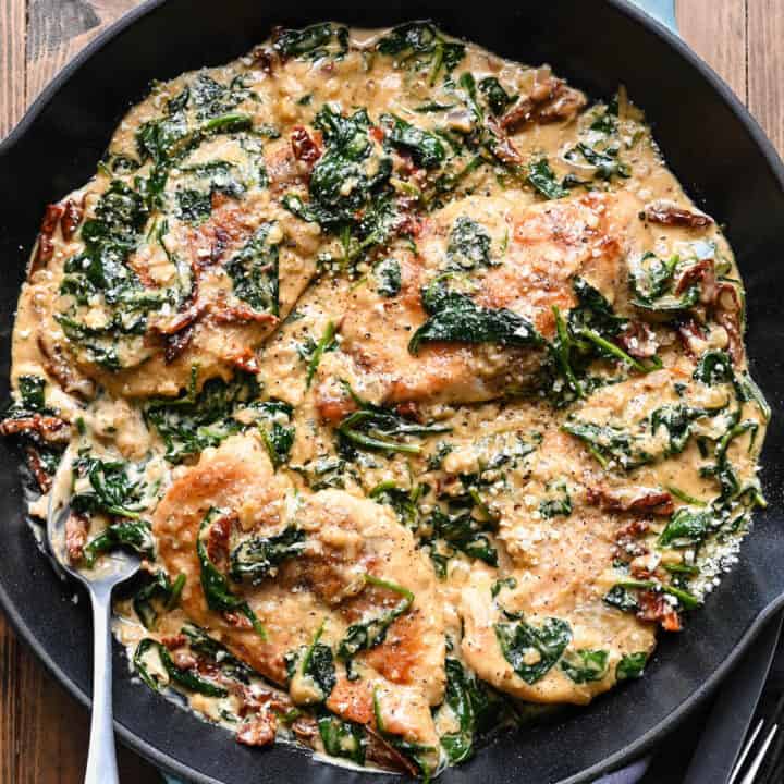 A cast iron skillet filled with a chicken Florentine recipe.