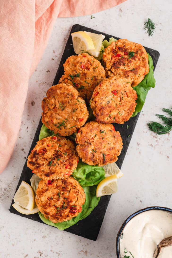 Canned salmon patties on a slate serving platter.