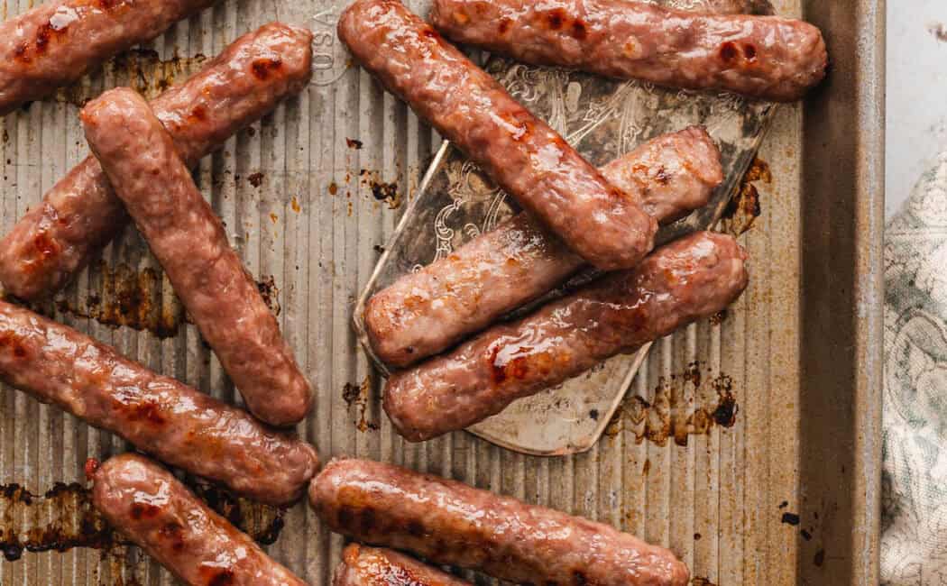 A photo demonstrating cooking sausage in the oven.