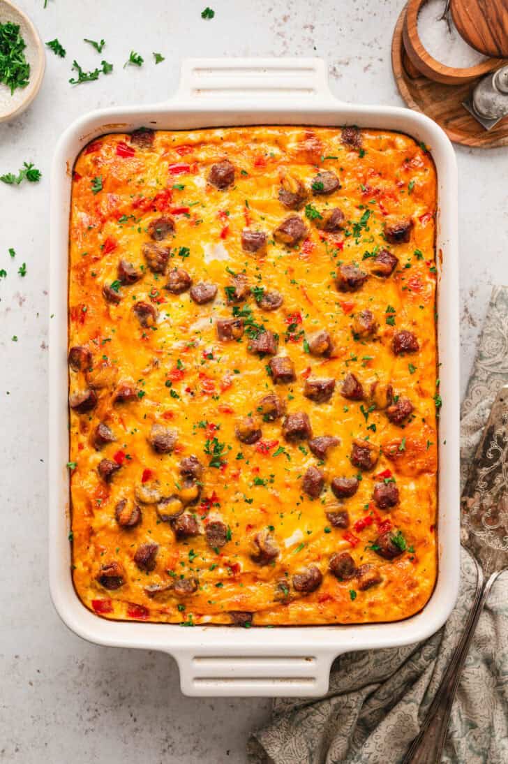 A white rectangular baking dish filled with breakfast sausage casserole.