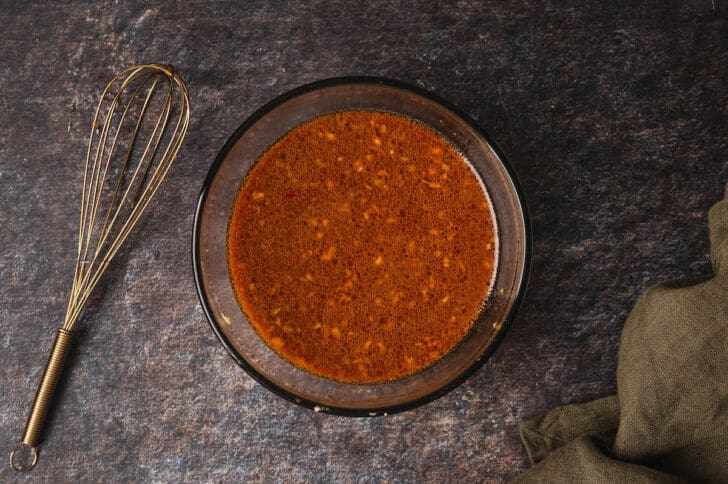 A glass bowl filled with a chunky orange-brown mixture.