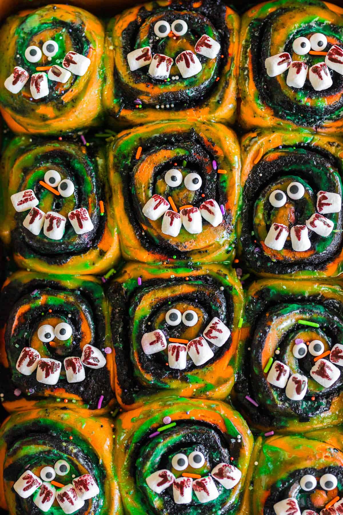 Spooky breakfast rolls decorated with candy eyeballs and marshmallows for "teeth."