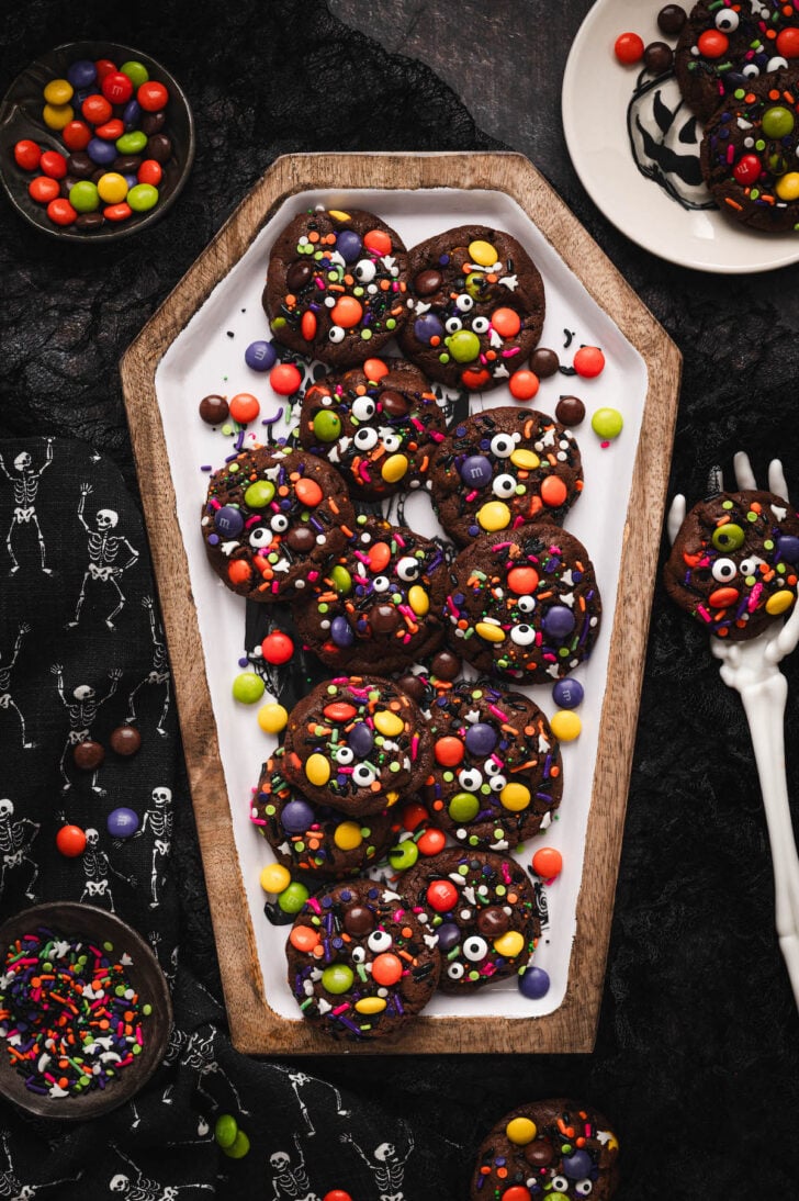 A pile of Halloween cookies on a coffin-shaped platter.