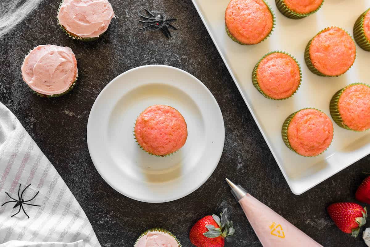 Small pink cakes about to be frosted.