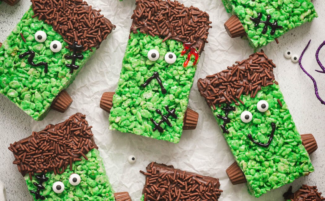 Halloween rice krispie treats on a white surface.