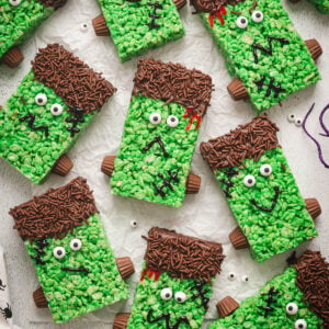 Halloween rice krispie treats on a white surface.